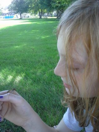 Joe's daughter handling a male wasp. Picture credit: Joe Ballenger